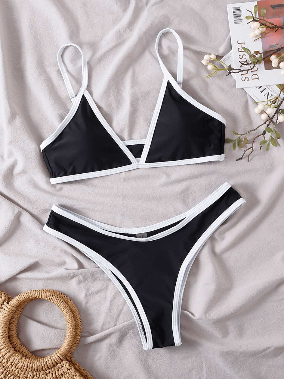 Stylish black micro bikini set with adjustable straps, laid flat with accessories, perfect for beachwear - SF0919